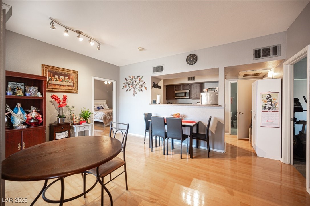 6650 West Warm Springs Road, Unit 1079 Las Vegas, NV 89118 - Photo 8 of 37 Dining space featuring light wood-style floors, visible vents, and baseboards