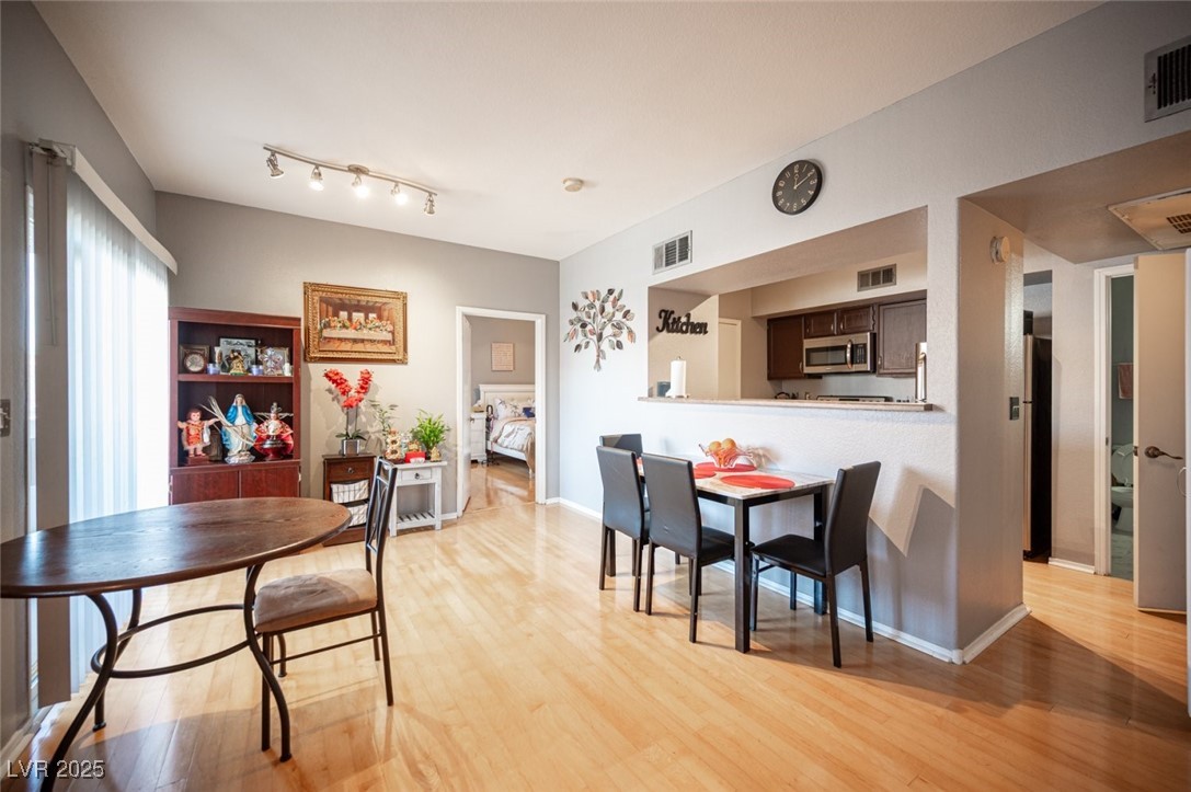 6650 West Warm Springs Road, Unit 1079 Las Vegas, NV 89118 - Photo 9 of 37 Dining area featuring light wood-style floors and visible vents
