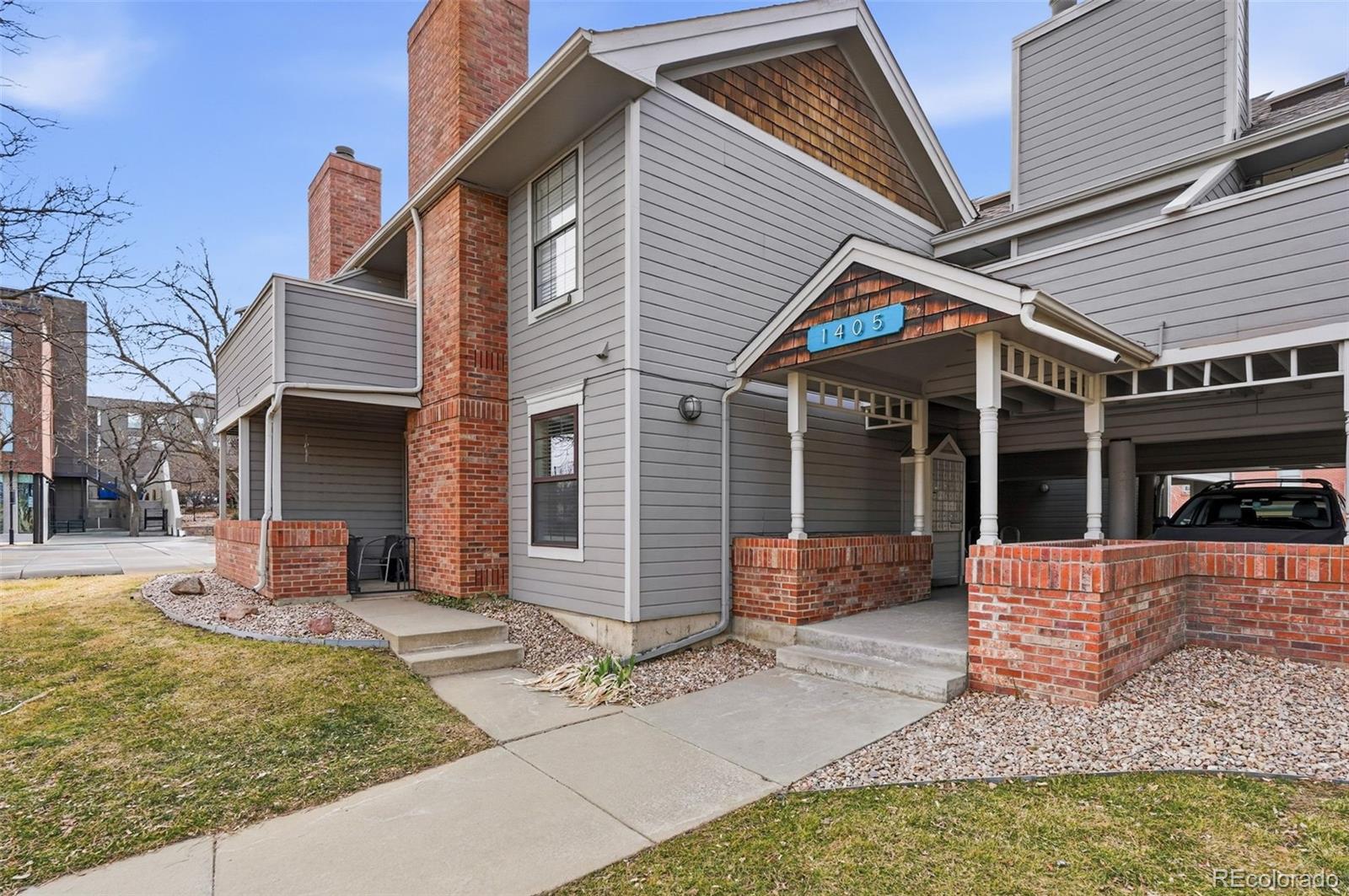 1405 Broadway, Unit 206 Boulder, CO 80302 - Photo 2 of 47 a front view of a house with a yard and glass windows