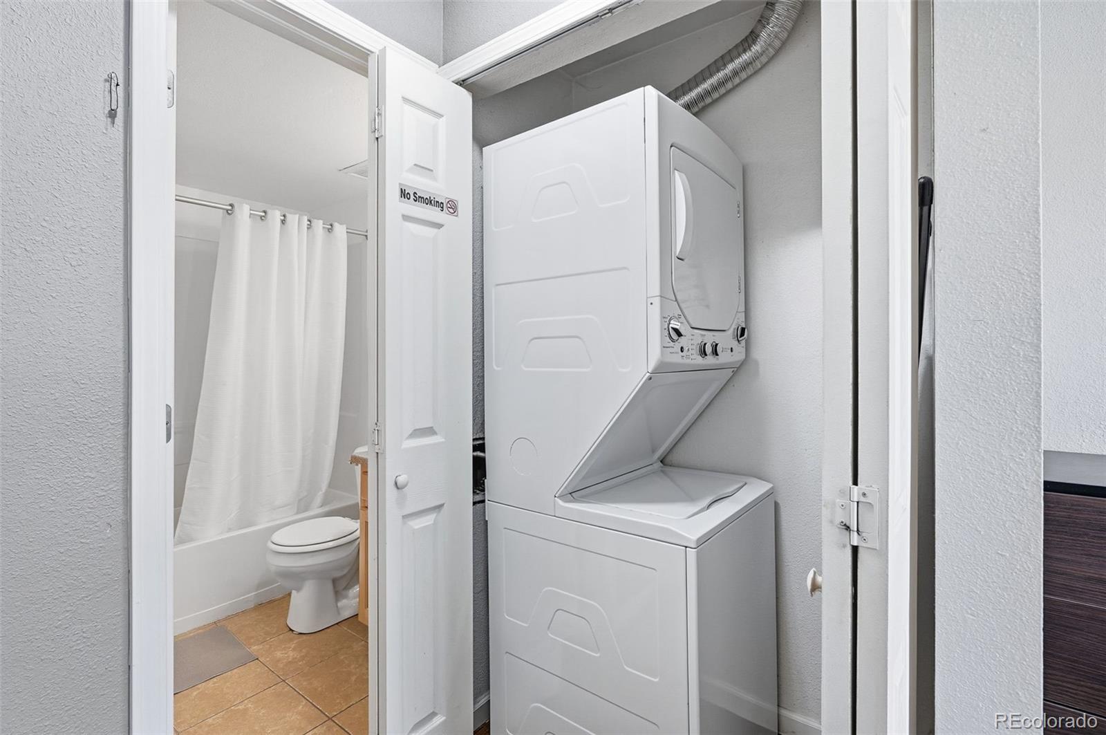 1405 Broadway, Unit 206 Boulder, CO 80302 - Photo 23 of 47 a view of bathroom with a washer and dryer