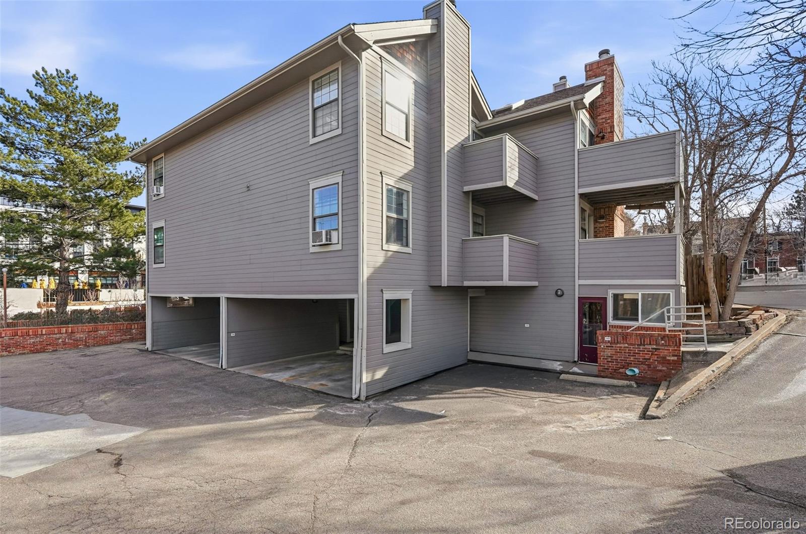 1405 Broadway, Unit 206 Boulder, CO 80302 - Photo 27 of 47 a front view of a house with a yard and garage