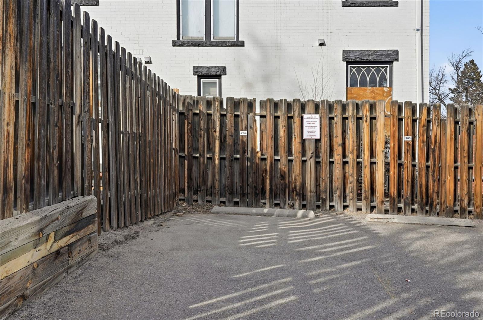 1405 Broadway, Unit 206 Boulder, CO 80302 - Photo 29 of 47 a view of a building with wooden fence