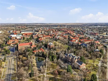 an aerial view of residential houses with city view