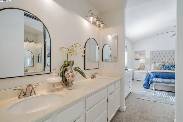 a bathroom with a double vanity sink and a mirror