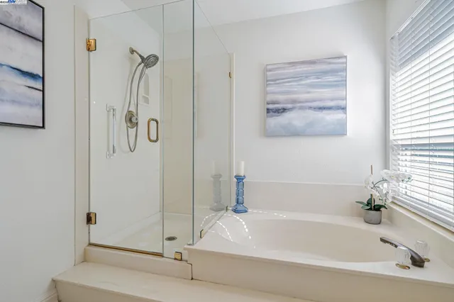 a bathroom with a tub and shower