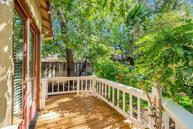 a view of a balcony with trees