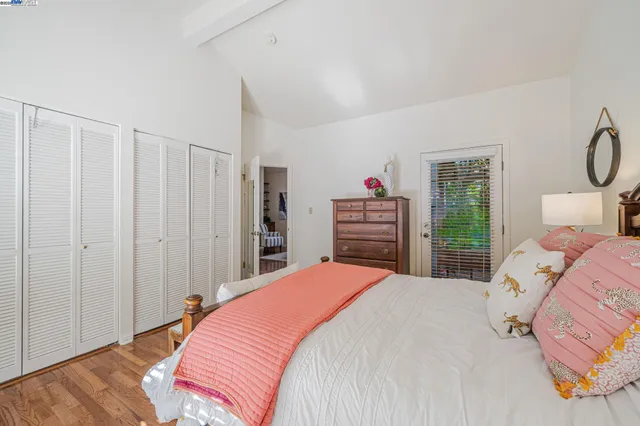 a bedroom with a large bed and a closet