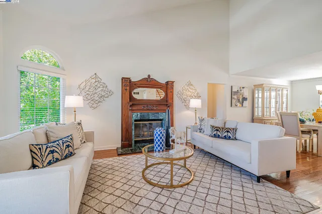 a living room with furniture a rug and a large window