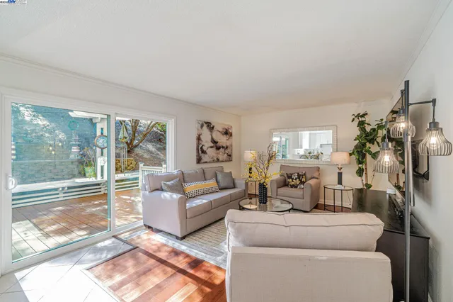 a living room with furniture and a floor to ceiling window