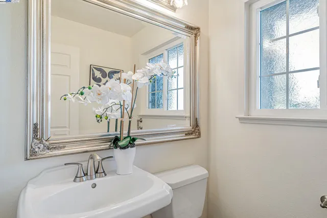 a bathroom with a sink a mirror and a toilet