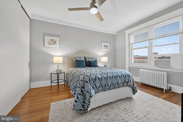 a bedroom with a large bed and a tv