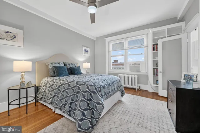 a spacious bedroom with a bed and a table in it