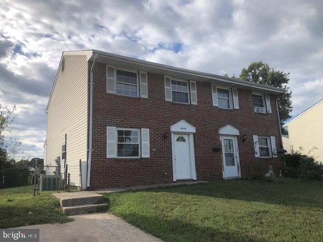 8535 Neptune Drive Pasadena, MD 21122 - Photo 1 of 7 a front view of a house with a yard