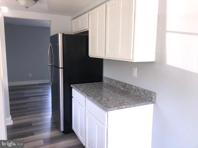 8535 Neptune Drive Pasadena, MD 21122 - Photo 2 of 7 a kitchen with stainless steel appliances granite countertop a refrigerator and a sink