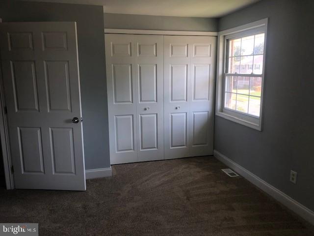 8535 Neptune Drive Pasadena, MD 21122 - Photo 4 of 7 an empty room with wooden floor and windows