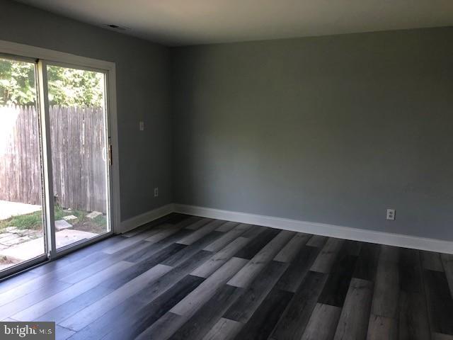 8535 Neptune Drive Pasadena, MD 21122 - Photo 5 of 7 a view of an empty room and wooden floor