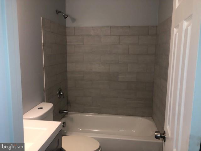 8535 Neptune Drive Pasadena, MD 21122 - Photo 6 of 7 a bathroom with a granite countertop bathtub shower sink vanity and toilet