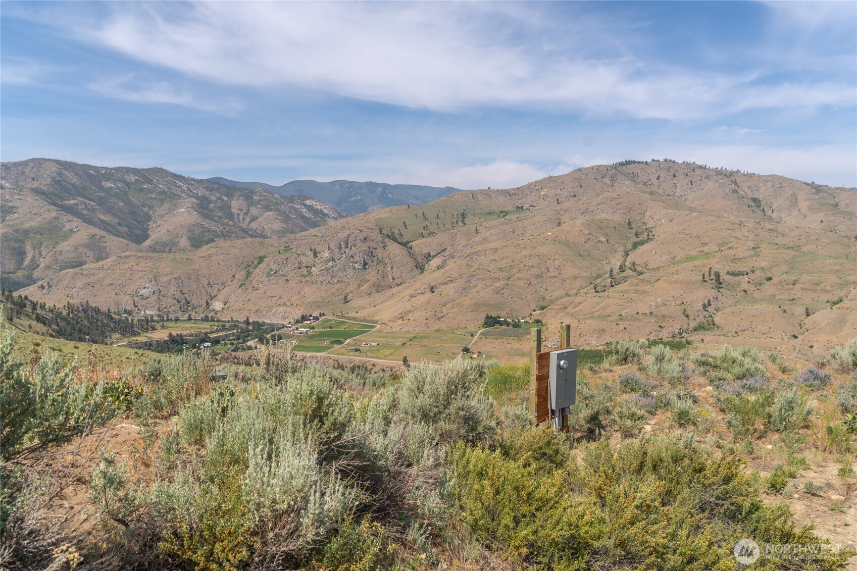 15 Cowboy Road Pateros, WA 98846 - Photo 4 of 15 a view of a dry yard with mountains in the background