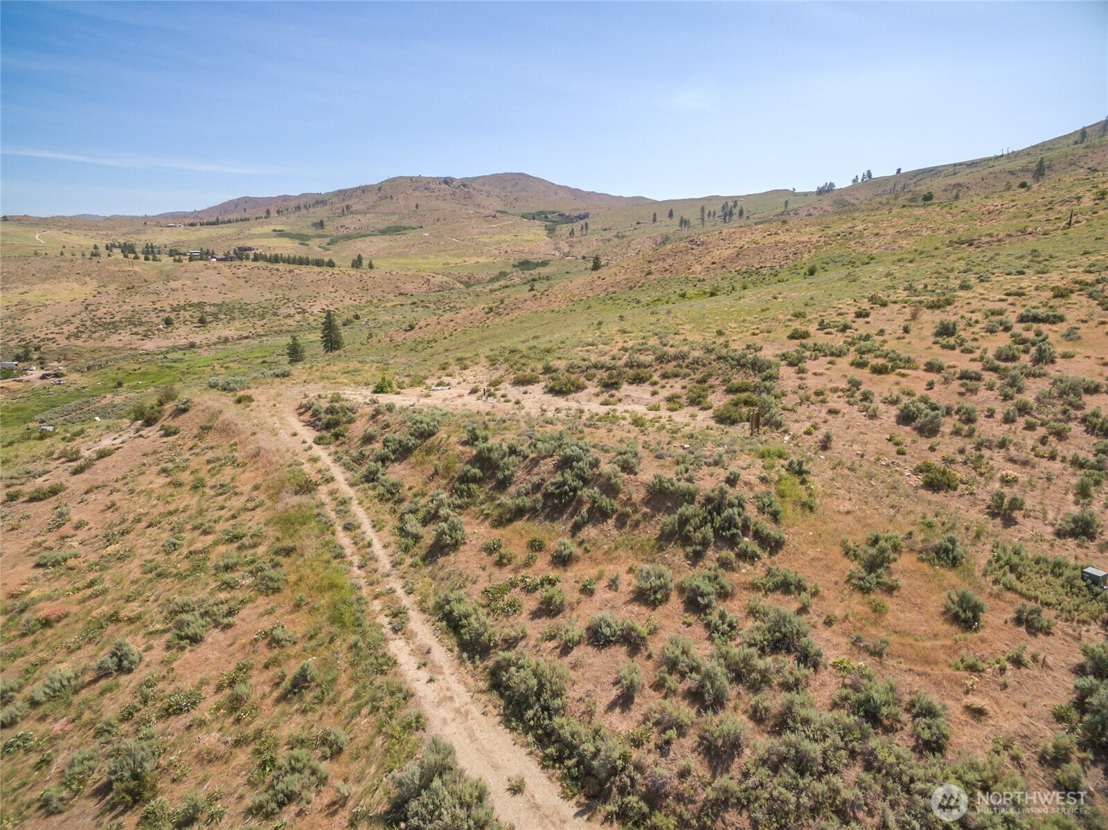 15 Cowboy Road Pateros, WA 98846 - Photo 9 of 15 a view of a dry yard with mountains in the background
