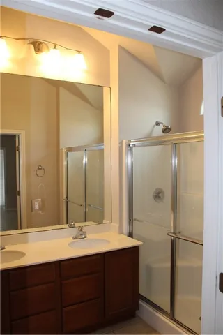 a bathroom with a granite countertop sink and a mirror