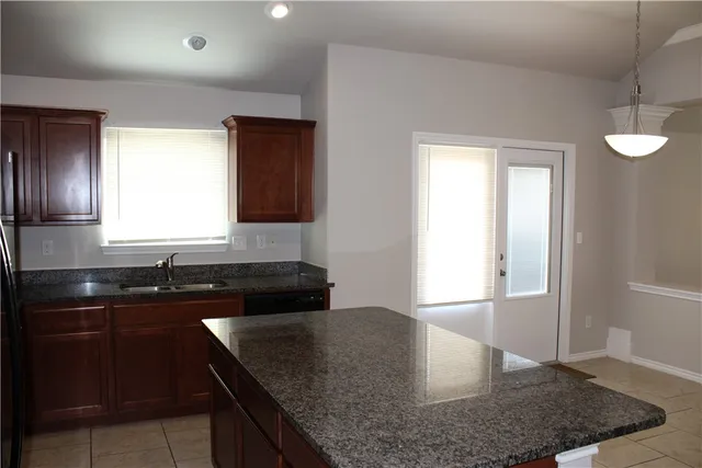 a kitchen with a stove a refrigerator and a microwave