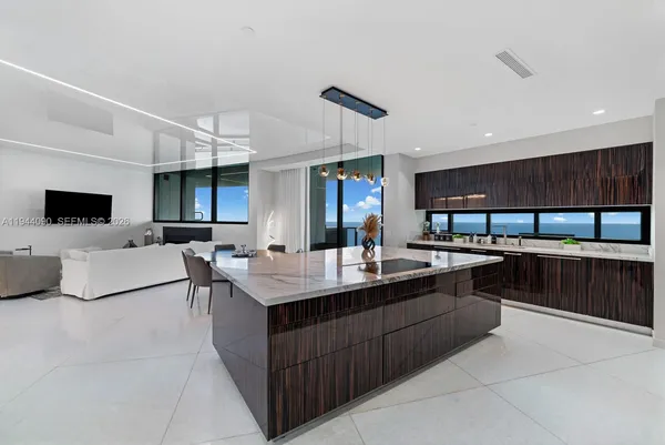 a kitchen with stainless steel appliances a sink a counter top space cabinets and a window