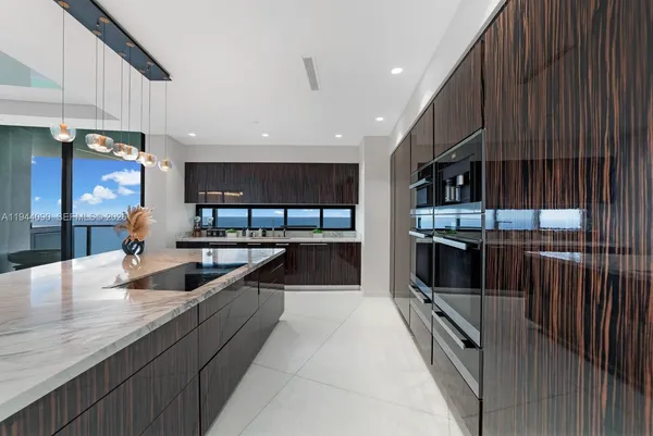 a kitchen with stainless steel appliances kitchen island granite countertop a large counter top and oven