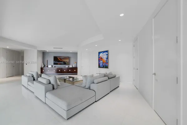 a spacious bedroom with a bed and ceiling fan