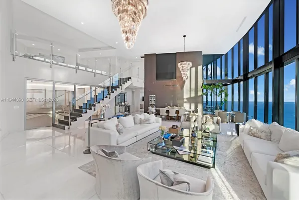 a living room with furniture and a chandelier
