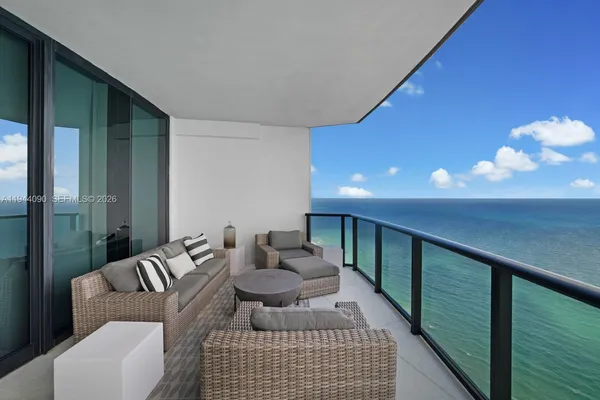 a balcony with furniture and a flat screen tv