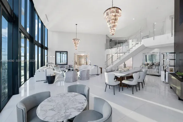 a living room with lots of furniture furniture and a chandelier