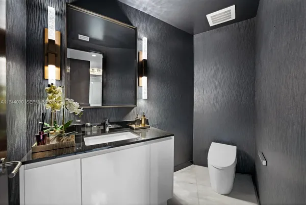 a living room with stainless steel appliances kitchen island a sink a counter top space and living room view