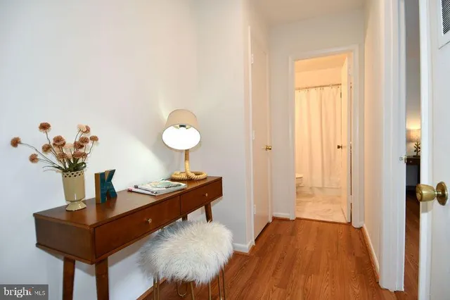a view of a room with a table and a potted plant