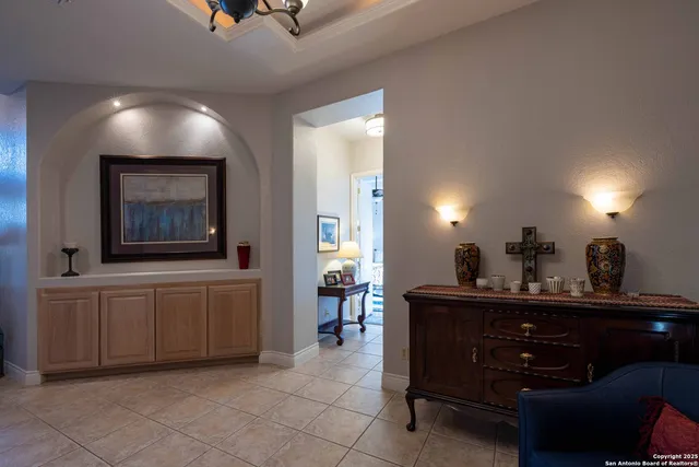 a living room with furniture and a lamp