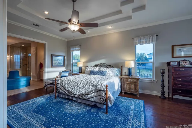 a spacious bedroom with a large bed and a chandelier