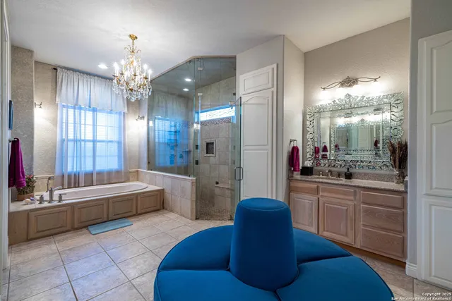 a large spacious bathroom with a double vanity sink a large mirror and a bathtub