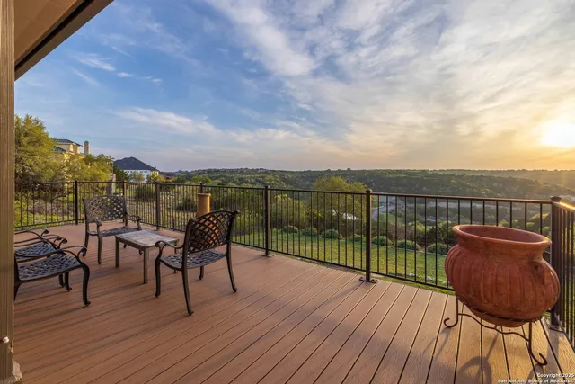 a view of a balcony with furniture and wooden floor