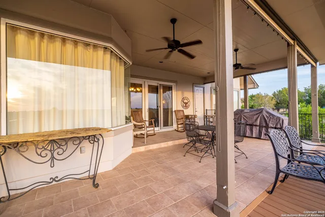 a very nice looking room with a large window with furniture and rug