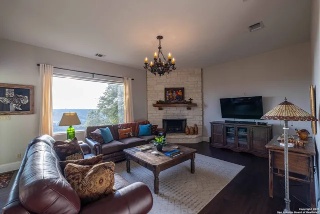 a living room with furniture a fireplace and a flat screen tv