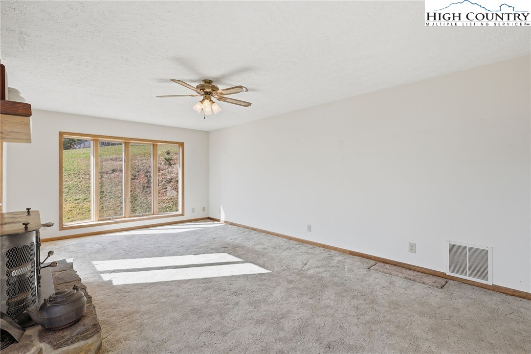 206 Lane L Massey Road Crumpler, NC 28617 - Photo 11 of 36 an empty room with windows and ceiling fan