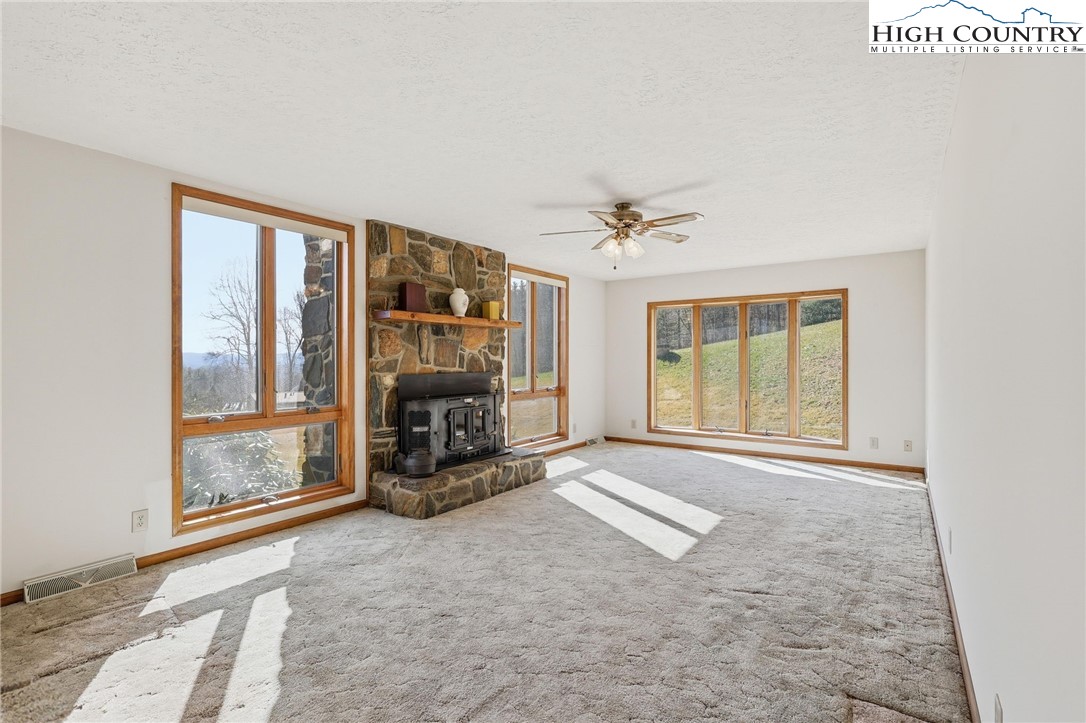 206 Lane L Massey Road Crumpler, NC 28617 - Photo 13 of 36 a view of an empty room with a fireplace and a window
