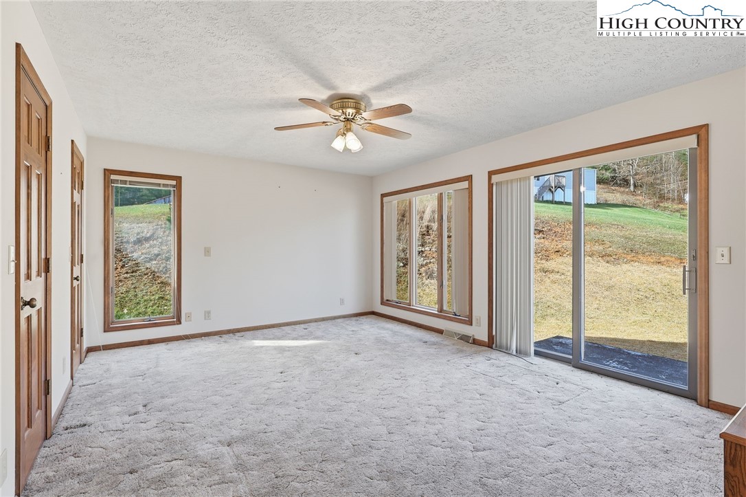 206 Lane L Massey Road Crumpler, NC 28617 - Photo 17 of 36 an empty room with windows and fan