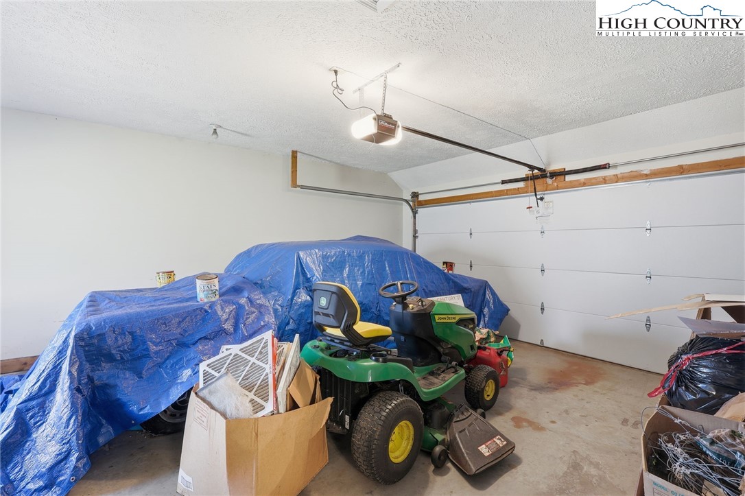 206 Lane L Massey Road Crumpler, NC 28617 - Photo 21 of 36 a bedroom with a bed and wooden floor