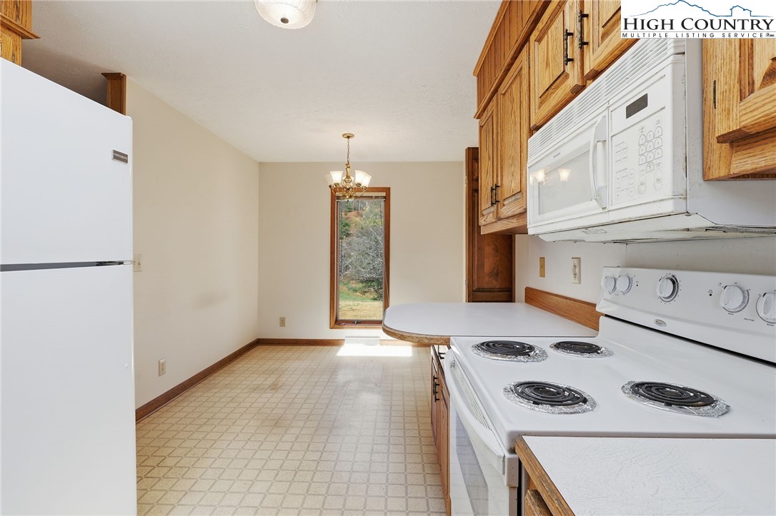 206 Lane L Massey Road Crumpler, NC 28617 - Photo 23 of 36 a kitchen that has a stove and a refrigerator
