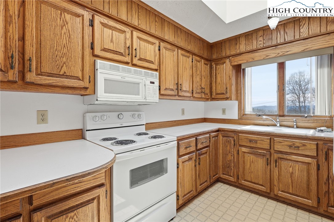 206 Lane L Massey Road Crumpler, NC 28617 - Photo 24 of 36 a kitchen with cabinets appliances a sink and a window