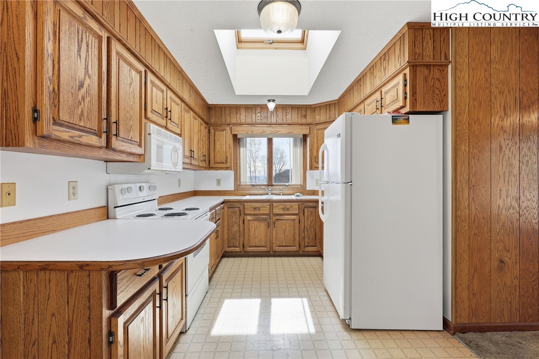 206 Lane L Massey Road Crumpler, NC 28617 - Photo 25 of 36 a kitchen with stainless steel appliances granite countertop a refrigerator a sink and a stove