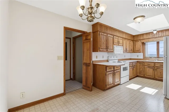 a kitchen with stainless steel appliances a white stove top oven and a refrigerator