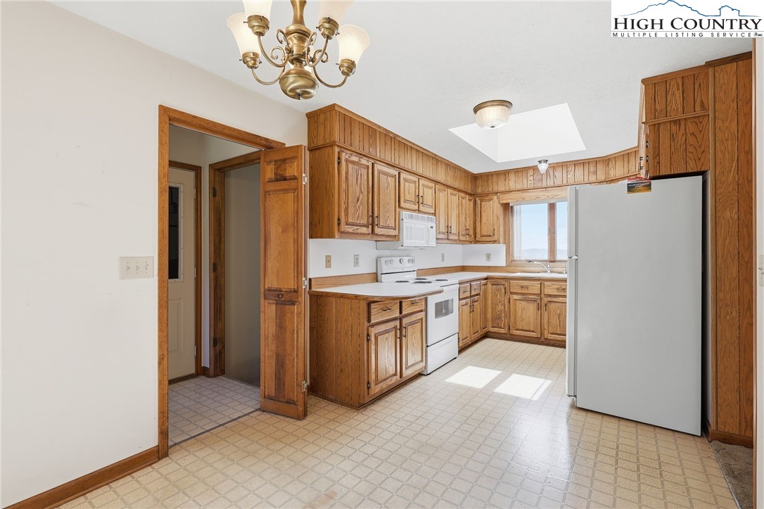 206 Lane L Massey Road Crumpler, NC 28617 - Photo 27 of 36 a kitchen with a refrigerator a sink and dishwasher