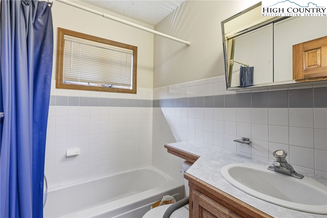 206 Lane L Massey Road Crumpler, NC 28617 - Photo 31 of 36 a bathroom with a sink and a bathtub