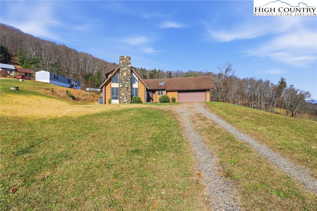 206 Lane L Massey Road Crumpler, NC 28617 - Photo 5 of 36 a front view of a house with a yard
